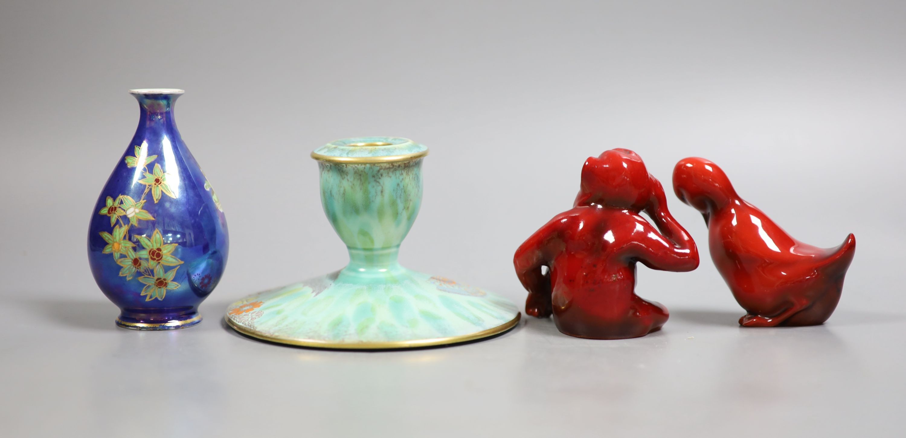 A Royal Doulton flambé figure of a monkey, 8.5 cm, a similar figure of a duck, a Carltonware lustre vase and a similar dwarf candlestick (4)